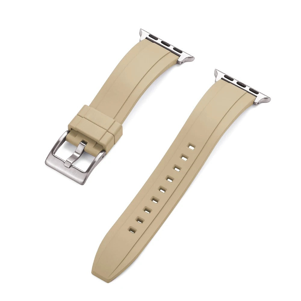 Close-up of a beige rubber Apple Watch strap with a silver buckle and adapter, shown detached into two pieces on a white background.