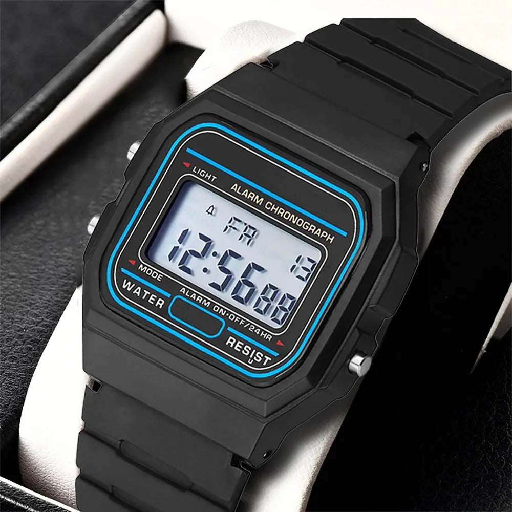Close-up of a classic black digital sports watch resting on a cushion, highlighting the screen and side buttons.