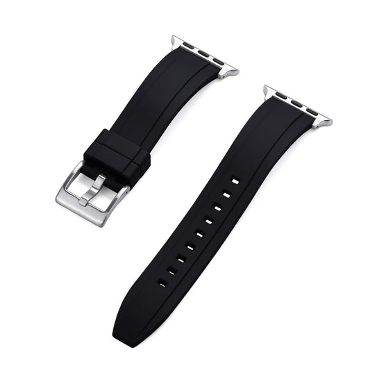 Close-up of a black rubber Apple Watch strap with a silver buckle and adapter, shown detached into two pieces on a white background.