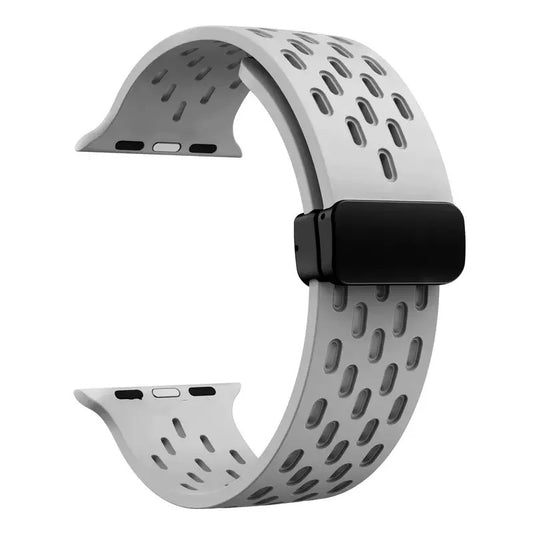 Gray perforated rubber sport strap for Apple Watch with black clasp, compatible with all Apple Watch sizes