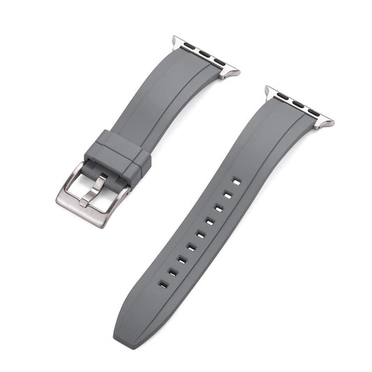 Close-up of a grey rubber Apple Watch strap with a silver buckle and adapter, shown detached into two pieces on a white background.