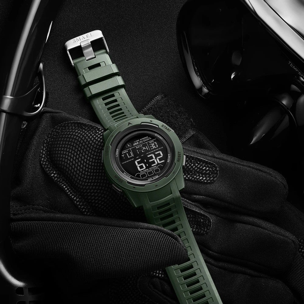 Olive green digital sports watch with clear LED display, sturdy rubber band, stopwatch, alarm, and water-resistant up to 50 meters.